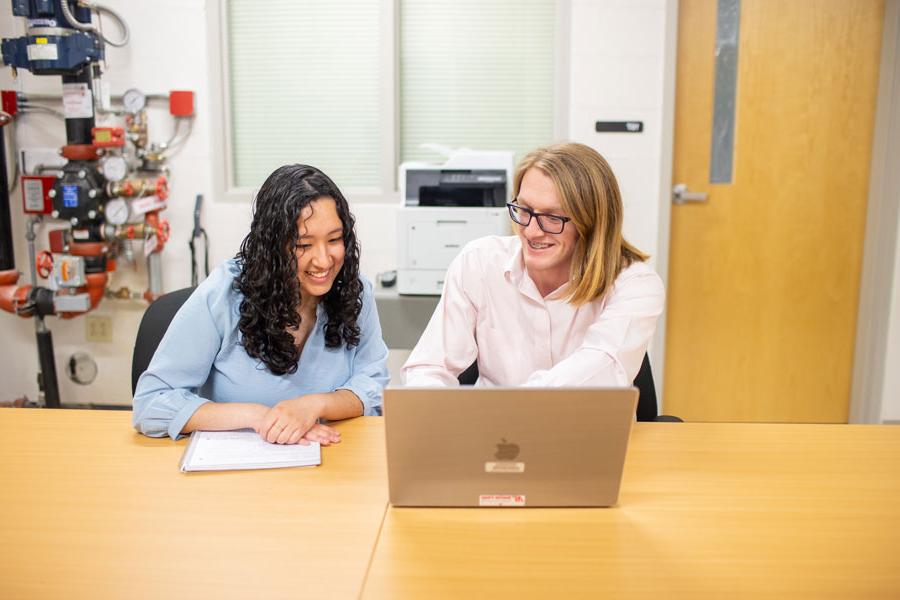 two students looking at a laptop together